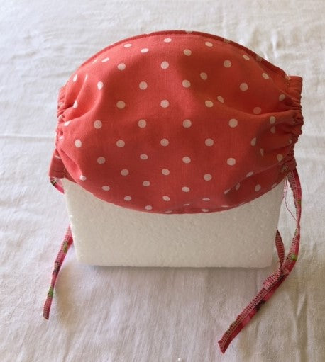 Peach and white polka dot mask